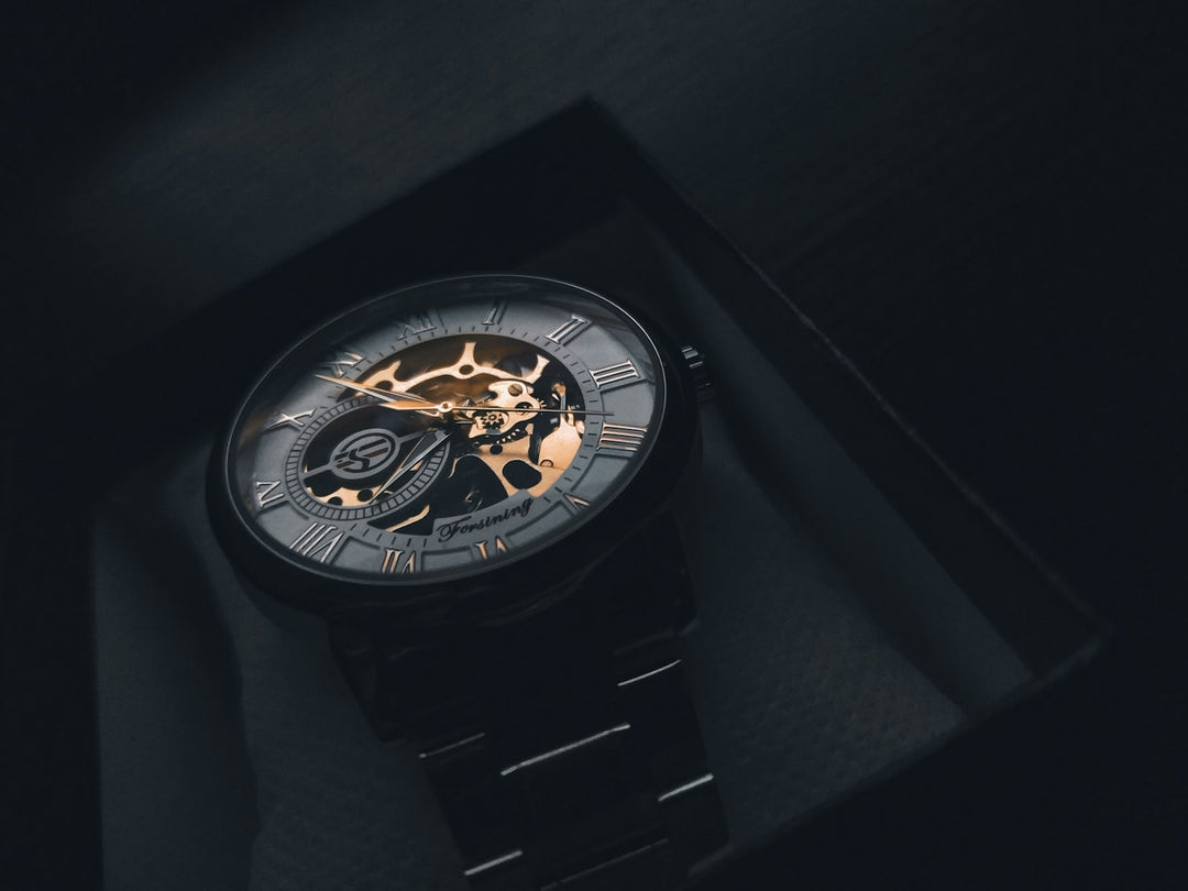 Skeletonised luxury sports watch on dark background