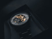 Skeletonised luxury sports watch on dark background