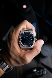 Tissot PRX watch held in hand